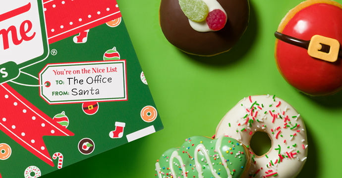 Krispy Kreme Christmas Doughnuts - Green background, flatlay with christmas packaging and christmas doughnuts featured