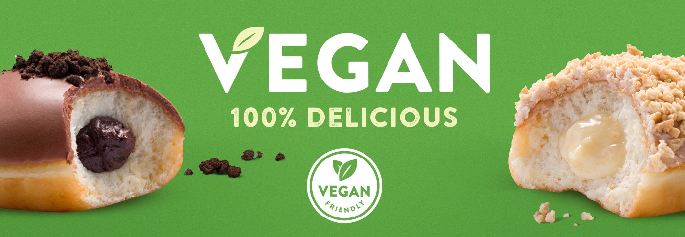 Vegan Douyghnut Range featuring the apple custard crumble doughnut and the fudge brownie bliss doughnut with bites taken out of them and the gooey fillings showing. Logo for Vegan Friendly included in image
