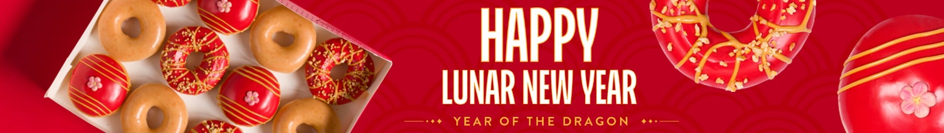 Banner featuring the words Happy Lunar New Year in white and gold text on a red background. A red iced ring doughnut with gold decoration and a red iced filled doughnut with a sugar flower in the middle, as well as a dozen box image - all top down.