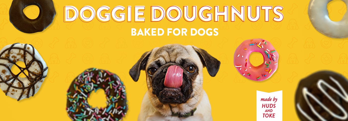 Krispy kreme Doggie Doughnuts pictured with a Pug dog licking his lips surrounded by floating Doggie Doughnut Products