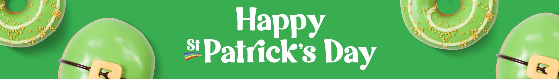 Banner featuring the words Happy St Patrick's Dayu in white text on a green background. Surrounded by green iced doughnuts, one with a belt buckle decoration, the other with a white spiral and gold sprinkles